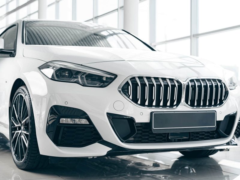 white-luxury-passenger-car-standing-inside-salon.jpg